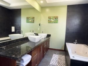 Modern bathroom with double sinks and a large bathtub in Dominical.