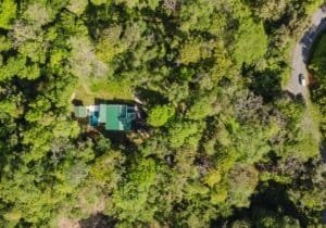 Aerial view of a private home surrounded by lush forest in Dominical, Costa Rica.