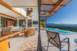 Balcony with mountain views, infinity pool, and outdoor seating in Dominical.