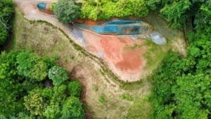 Aerial view of lush land with water features and surrounding greenery in Dominical.