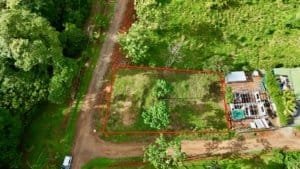 Build-ready 0.2-acre private lot in Uvita hills with trees and access road.