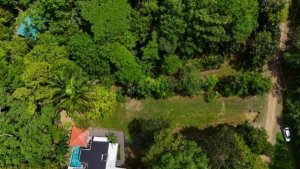 Aerial view of lush green land with creek access near Dominical, Costa Rica.