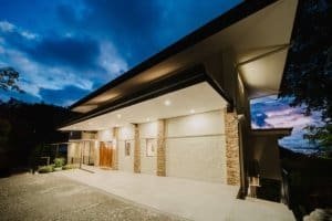 Modern luxury estate in Costa Rica with ocean and jungle views at dusk.