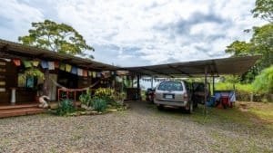 Carport with vehicles and lush greenery in Dominical, Costa Rica.