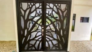 Decorative metal door with tree branch design in Dominical, Costa Rica.