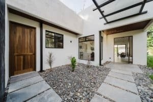 Modern Costa Rican home with stone pathway and minimalist design.