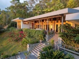 Modern luxury home with panoramic mountain views and lush gardens in Dominical.