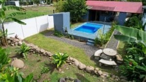 Beautiful backyard with private pool, lush garden, and outdoor seating area.
