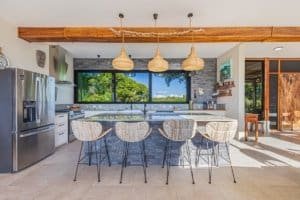 Contemporary kitchen with mountain views, island, and stylish decor.
