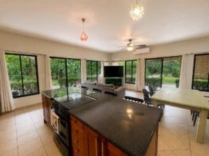 Bright living room with large windows and garden view in Dominical.