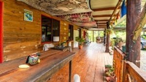 Cozy mountain home porch with wooden decor and lush greenery in Dominical.