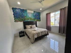 Bright bedroom with modern decor and colorful wall art in Dominical.