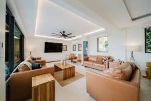 Spacious living room with ocean and jungle views, modern decor, and natural light.