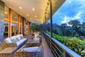 Balcony with seating overlooking lush mountain landscape in Dominical, Costa Rica.