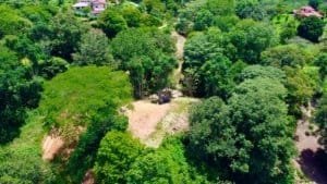 A lush green property with mountain views and easy access in Dominical, Costa Rica.
