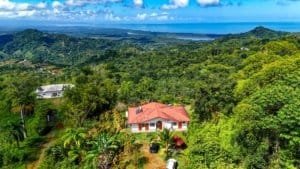 Beautiful ocean view from a lush green property with a house and lodge in Dominical.