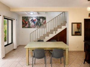 Interior view of a Costa Rican villa with dining area and staircase.