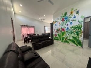 Spacious living room with colorful jungle mural and modern furniture in Dominical.