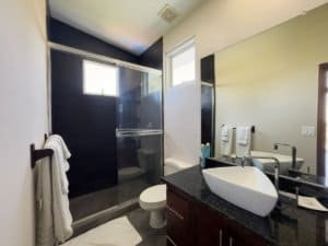 Contemporary bathroom with shower, sink, and window in Costa Rica.
