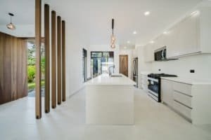 Contemporary kitchen with white cabinets and island in Costa Rica.