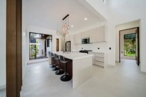 Contemporary kitchen with white cabinets and island in Dominical Costa Rica.