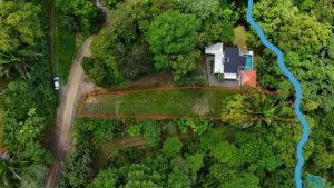 A lush green 0.25-acre lot with creek access near Dominical Beach, Costa Rica.