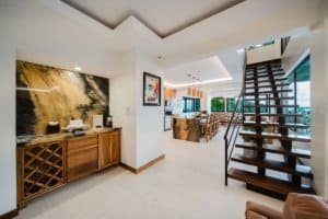 Modern interior with staircase, artwork, and ocean view in Costa Rica.