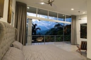 Spacious bedroom with panoramic mountain view and balcony in Dominical.