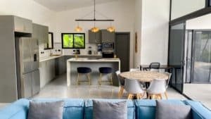 Spacious modern kitchen with dining area near large glass windows in Dominical.