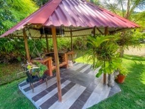 Outdoor gazebo with seating and lush tropical plants in Costa Rica.