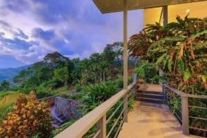 Balcony overlooking lush tropical landscape and mountains in Dominical.