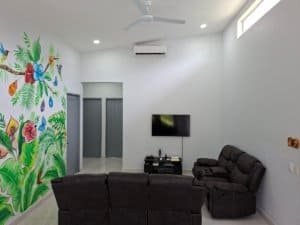 Spacious living room with colorful wall art and modern furniture in Dominical.