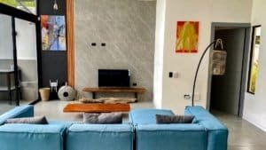 Bright, modern living room with blue sofas and contemporary decor.