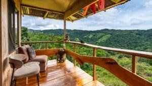 Balcony with seating overlooking lush green mountains in Dominical, Costa Rica.