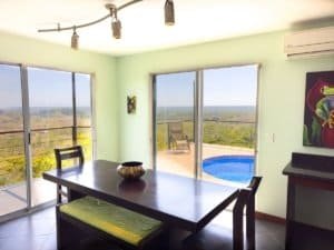 Bright dining area with panoramic ocean and mountain views in Dominical.