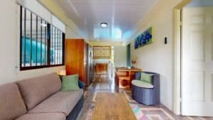 Interior view of a cozy Costa Rican home with living area and hallway.