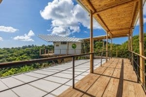 Wooden deck with mountain views and lush greenery in Dominical, Costa Rica.