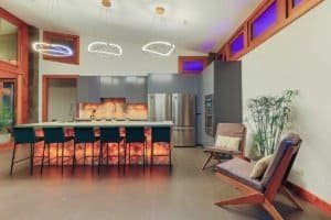 Contemporary kitchen with island, stainless appliances, and mountain view windows.