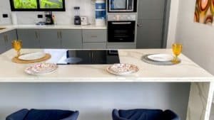 Contemporary kitchen with dining table, plates, and glasses in Costa Rica.