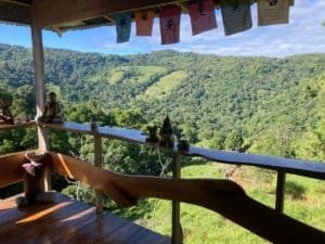 Scenic mountain view from a balcony in Dominical, Costa Rica with lush greenery.