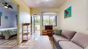 Interior view of a charming Costa Rican home with sofa and balcony.