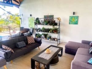 Living room with modern furniture, artwork, and ocean view in Dominical.