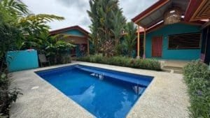 Swimming pool with tropical garden and villas in Dominical.