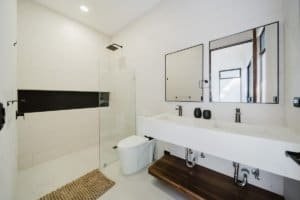 Contemporary bathroom with walk-in shower, double vanity, and minimalist design.