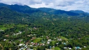 Scenic view of lush green mountains and residential area in Dominical.