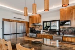 Modern kitchen with wooden cabinets, stainless steel appliances, and ocean view.