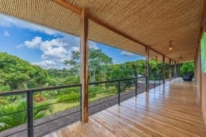 Spacious balcony overlooking lush green mountains in Dominical, Costa Rica.
