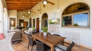 Bright indoor living space with large windows and tropical decor.