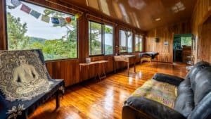 Cozy mountain home interior with large windows and wooden decor.