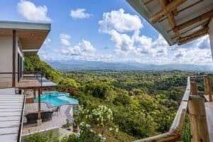Stunning mountain view from a luxury Costa Rica estate with pool and balcony.